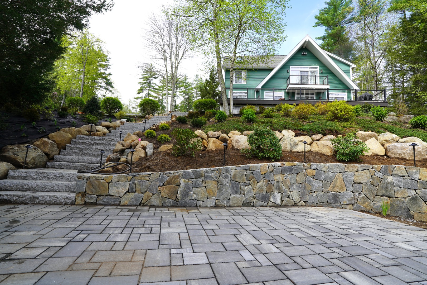 sloped yard terraced with natural stone retaining walls