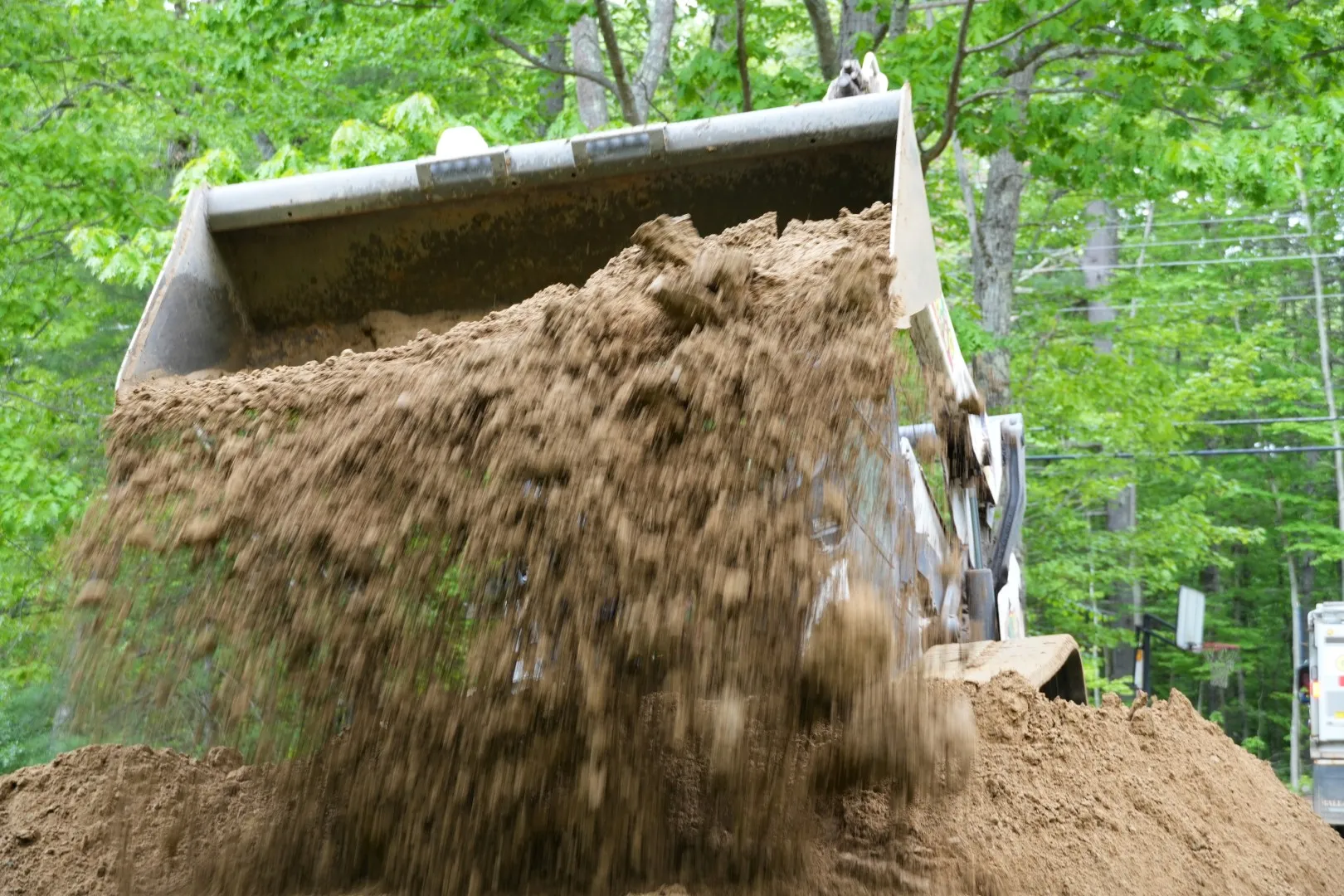 skidsteer dumping topsoil